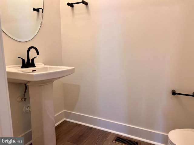 bathroom featuring toilet and hardwood / wood-style floors