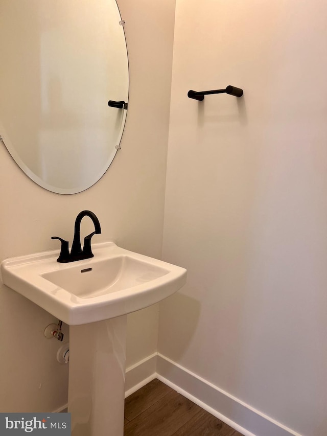 bathroom with hardwood / wood-style floors