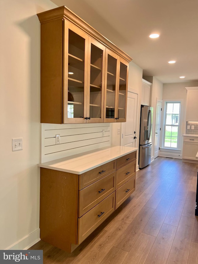 kitchen featuring light hardwood / wood-style flooring and stainless steel refrigerator with ice dispenser