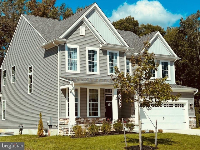 craftsman house featuring covered porch, a front lawn, and a garage