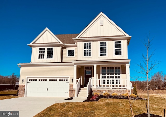 view of front of property with covered porch, a front yard, and a garage