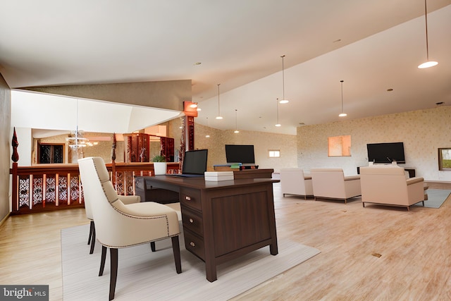 interior space with a notable chandelier, light wood-type flooring, and vaulted ceiling