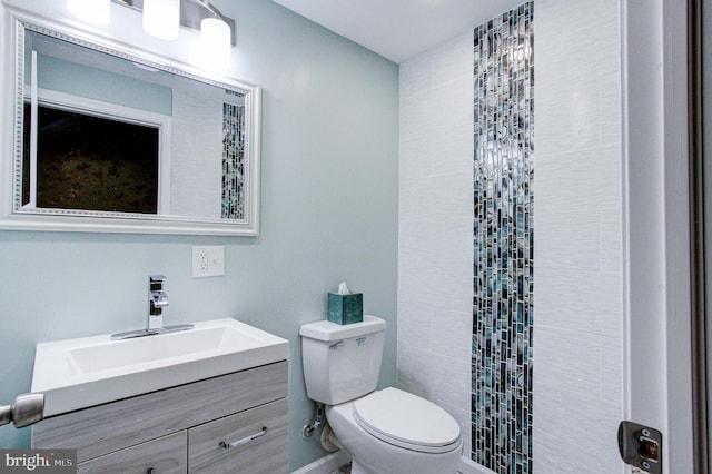 bathroom featuring toilet and vanity