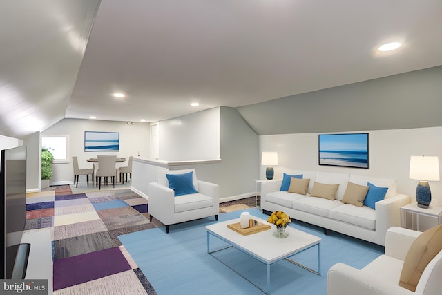 carpeted living room featuring lofted ceiling