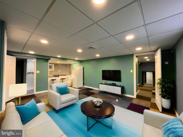 living room with a paneled ceiling