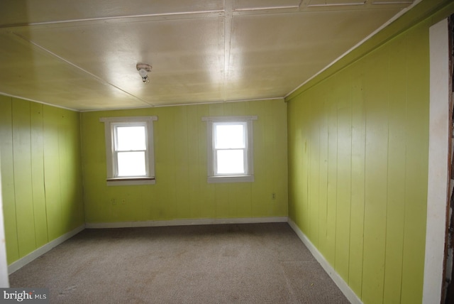 spare room with lofted ceiling and light colored carpet