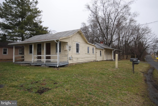 rear view of property featuring a yard