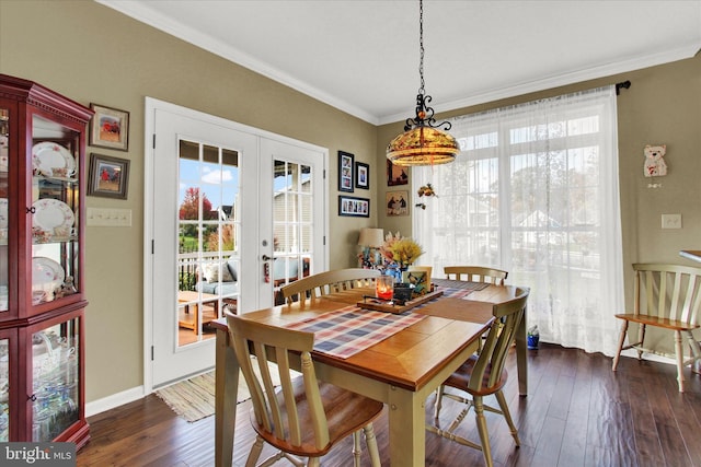 dining space with ornamental molding, french doors, and dark hardwood / wood-style flooring