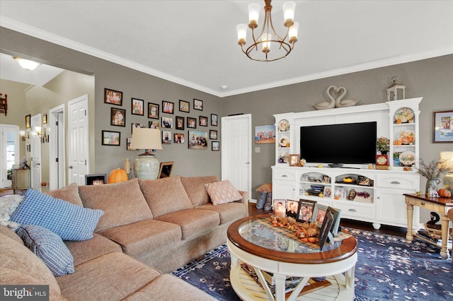 living room featuring ornamental molding, dark wood-type flooring, and an inviting chandelier