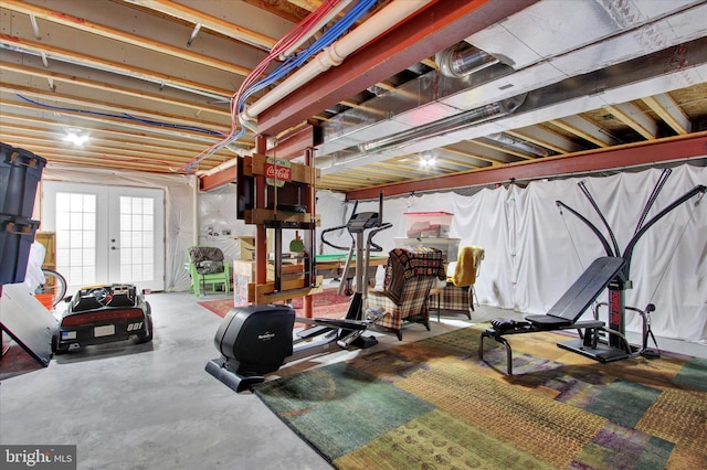 workout room featuring french doors and concrete flooring