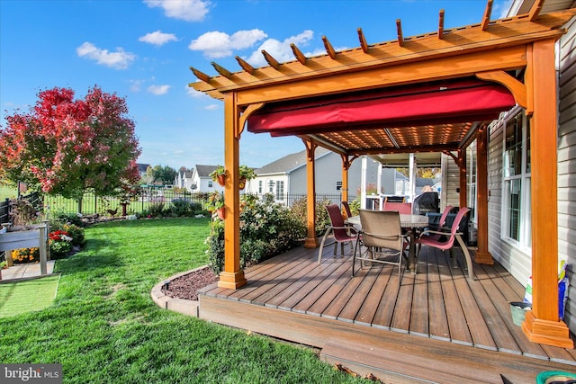 wooden terrace featuring a lawn and a pergola