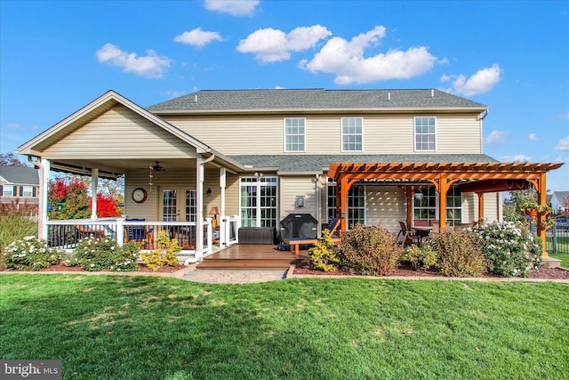 view of front of home featuring a pergola, a front lawn, and a deck