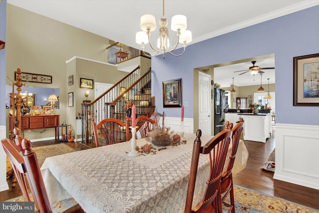 dining room featuring ornamental molding, ceiling fan with notable chandelier, and dark hardwood / wood-style floors