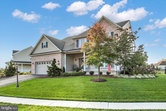 view of front of house featuring a porch, a front lawn, and a garage