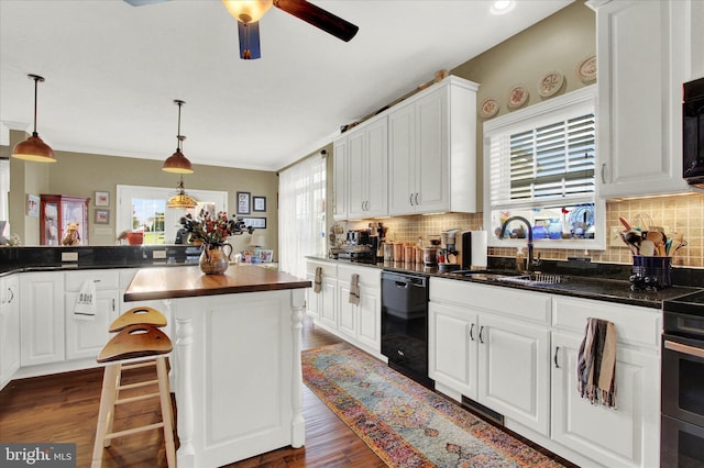 kitchen featuring backsplash, pendant lighting, ceiling fan, and black appliances