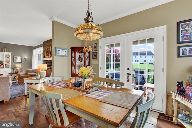 dining room featuring crown molding, dark wood-type flooring, and french doors