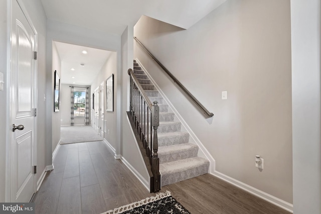 staircase with dark wood-type flooring