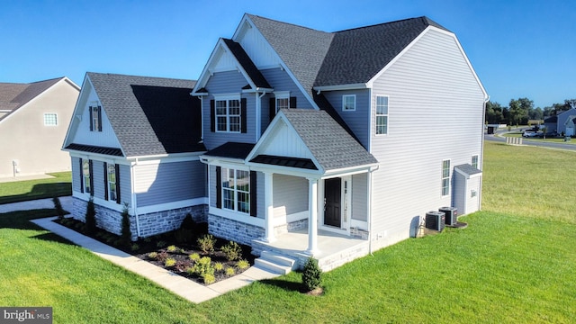 view of property exterior featuring a yard, roof with shingles, stone siding, and central air condition unit