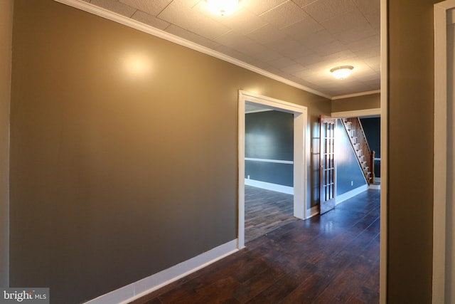 corridor with ornamental molding and dark hardwood / wood-style floors