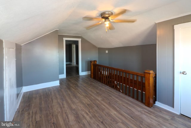 bonus room featuring ceiling fan, lofted ceiling, and dark hardwood / wood-style flooring