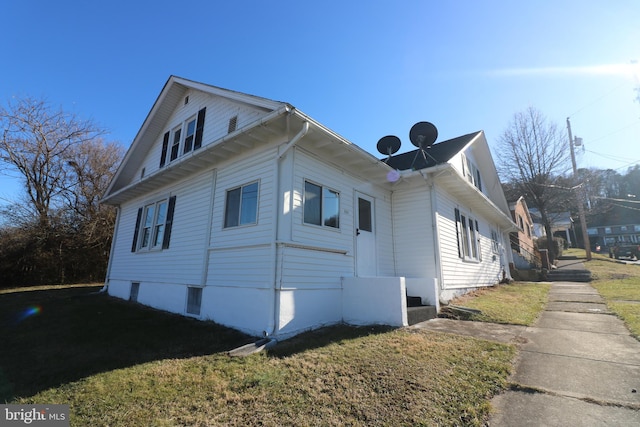 view of side of home featuring a lawn