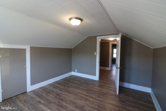 additional living space with dark hardwood / wood-style flooring and lofted ceiling