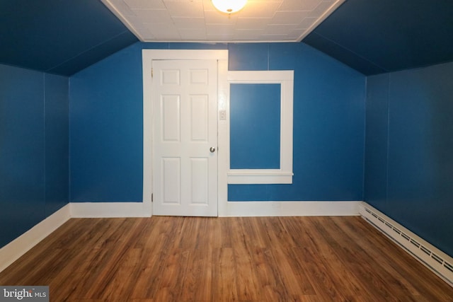 bonus room with lofted ceiling, dark wood-type flooring, and a baseboard heating unit