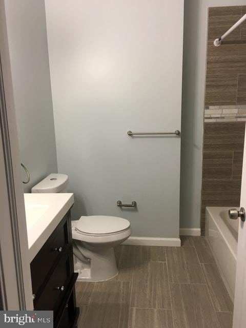 full bathroom with shower / bathing tub combination, tile floors, toilet, and vanity