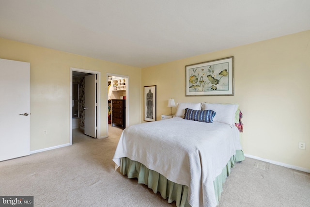 carpeted bedroom featuring a closet and a spacious closet