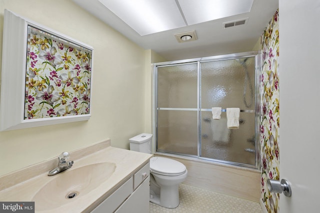 full bathroom with vanity, tile flooring, enclosed tub / shower combo, and toilet