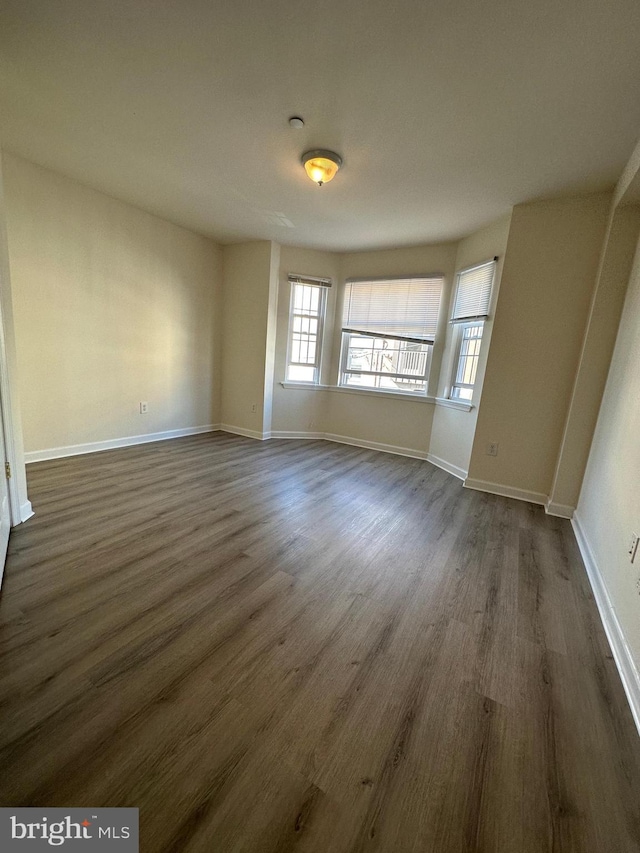 spare room featuring dark hardwood / wood-style floors