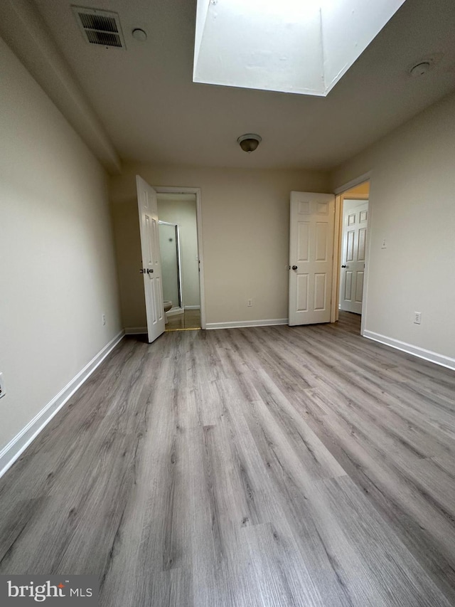 unfurnished bedroom featuring light wood-type flooring