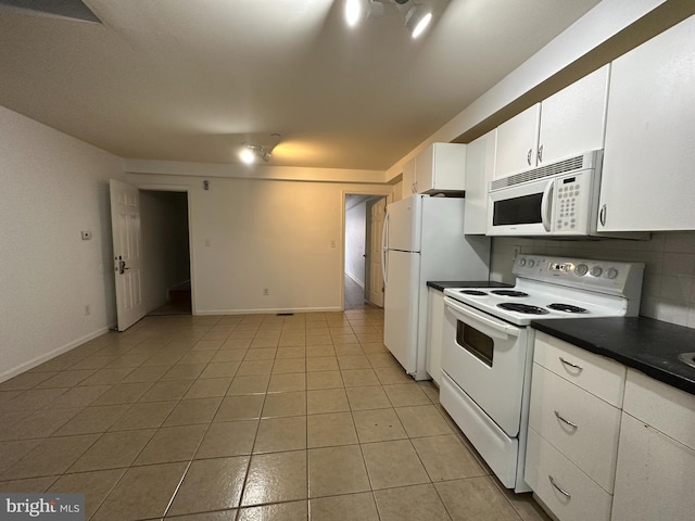 kitchen with white appliances, backsplash, white cabinetry, and light tile floors