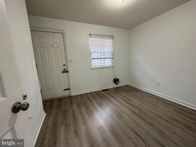 spare room featuring dark hardwood / wood-style floors