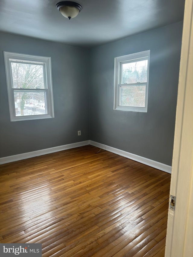 spare room with hardwood / wood-style flooring