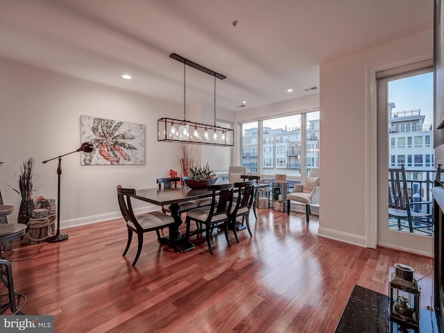 dining room featuring a notable chandelier and light hardwood / wood-style flooring