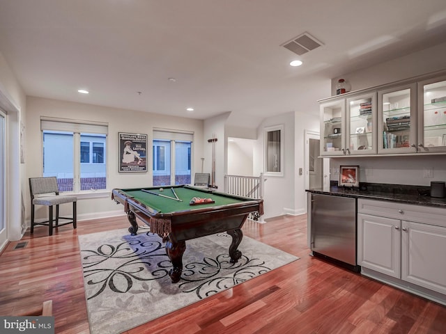 game room featuring billiards, indoor bar, and hardwood / wood-style flooring