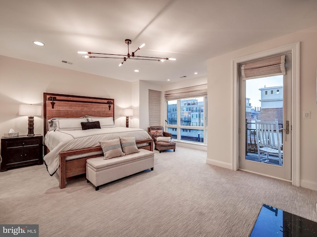 bedroom featuring access to exterior, a notable chandelier, and light carpet