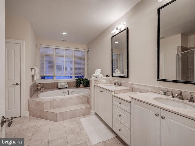 bathroom with oversized vanity, double sink, plus walk in shower, and tile flooring
