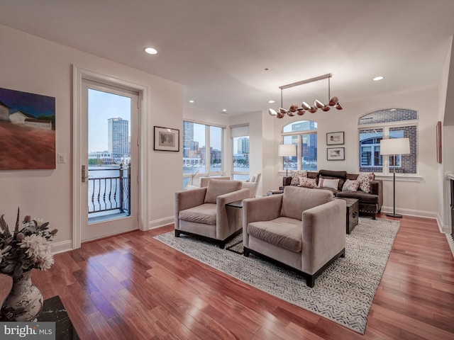 living room with a notable chandelier and hardwood / wood-style floors