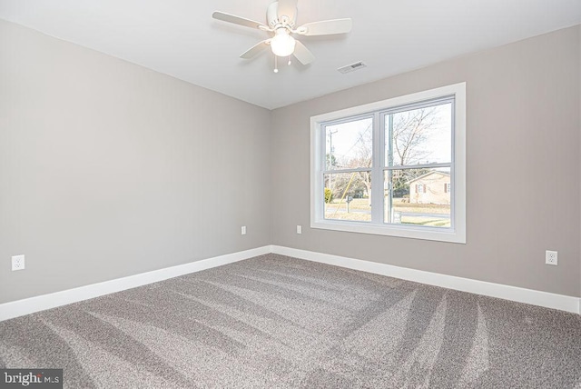 empty room with ceiling fan and carpet flooring