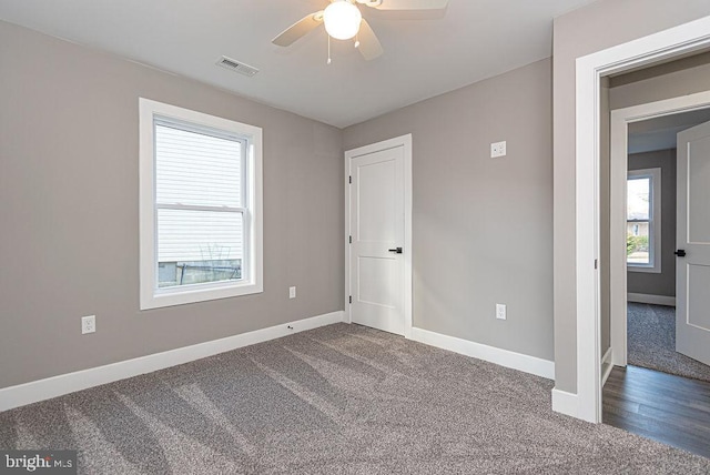 empty room featuring dark hardwood / wood-style flooring and ceiling fan