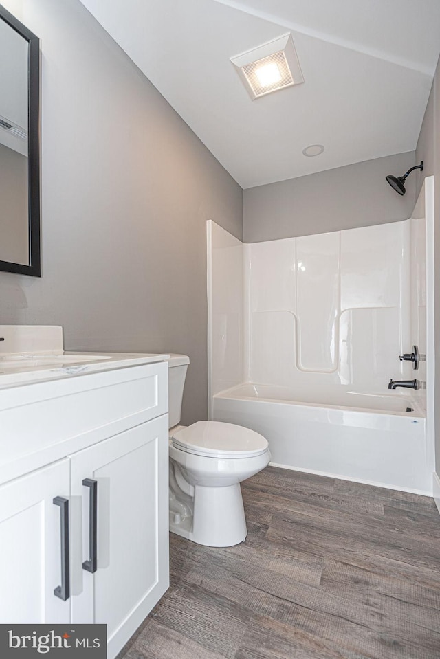 full bathroom with toilet, shower / bathtub combination, vanity, and wood-type flooring