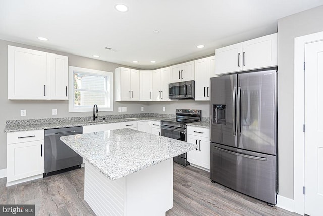 kitchen with white cabinetry, light hardwood / wood-style floors, and appliances with stainless steel finishes