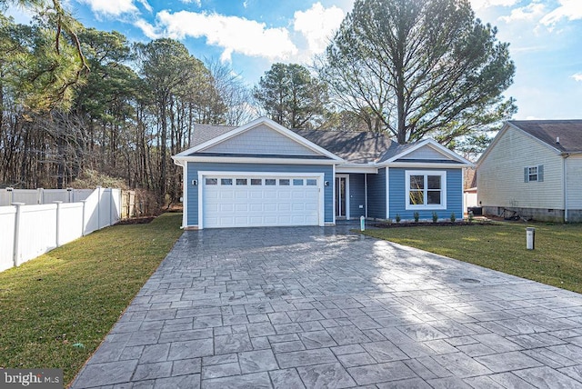 view of front of house featuring a front lawn and a garage