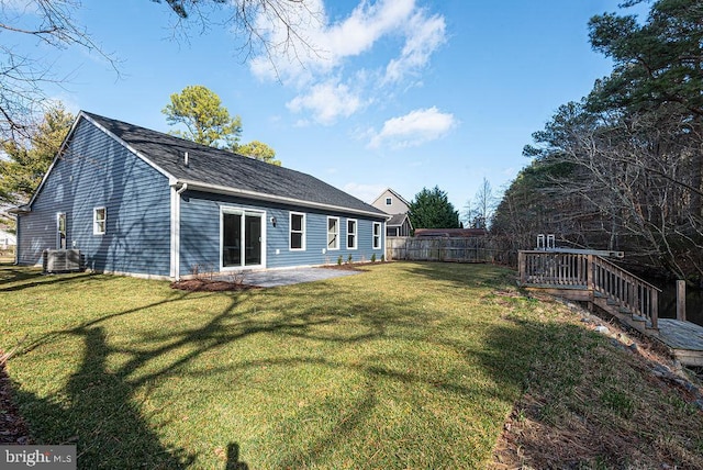 rear view of house with a patio area and a lawn