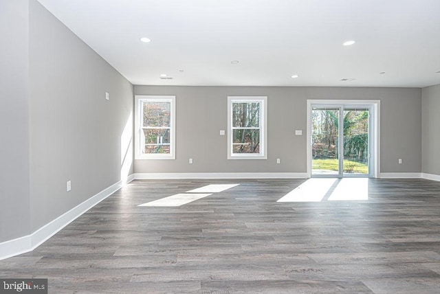 unfurnished room with dark hardwood / wood-style floors