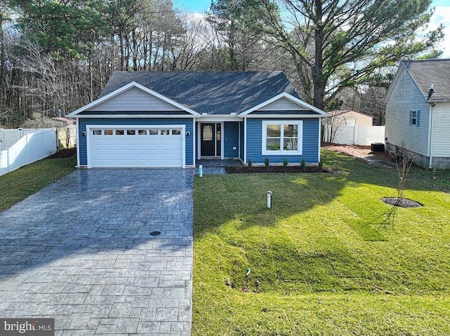 view of front of home featuring a front yard and a garage