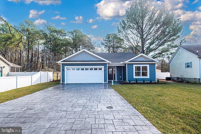 single story home with a front yard and a garage