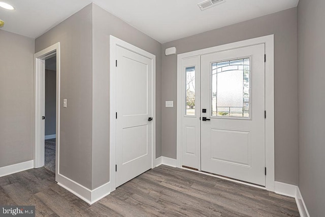 entryway with dark wood-type flooring